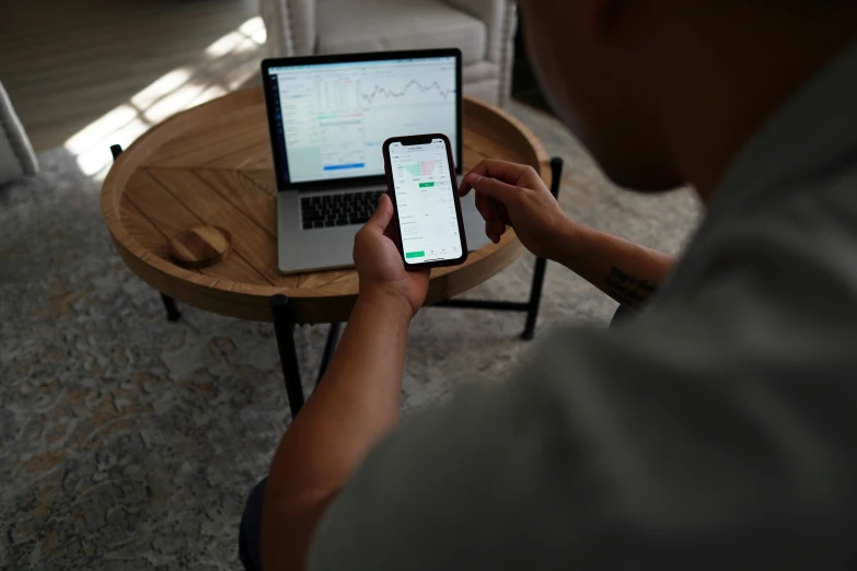 a man sitting in front of a laptop computer, trending on pexels, taken on an iphone, car trading game, product introduction photo