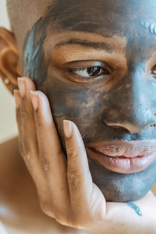 a close up of a person with a face mask, pleasing face, charcoal skin, lean man with light tan skin, ebony skin