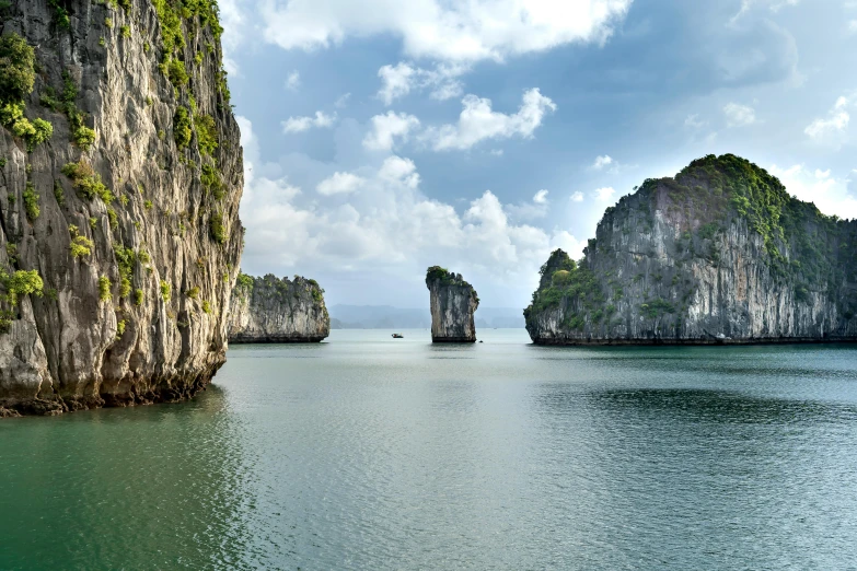 a body of water that has some rocks in it, inspired by Pierre Pellegrini, pexels contest winner, vietnam, two medium sized islands, limestone, multicoloured