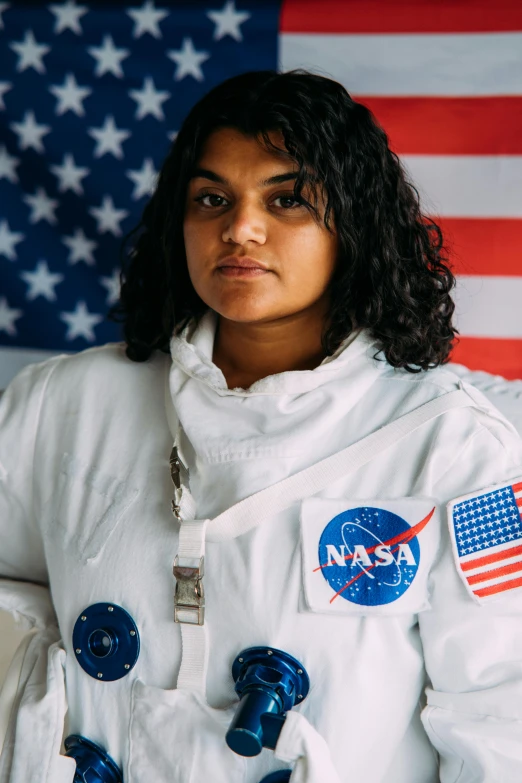 a woman standing in front of an american flag, portrait of astronaut, jayison devadas, full costume, profile image