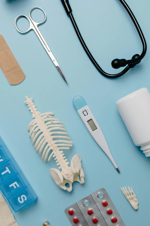 medical supplies laid out on a blue surface, a still life, trending on pexels, conceptual art, white bones, profile image, high temperature, nurse