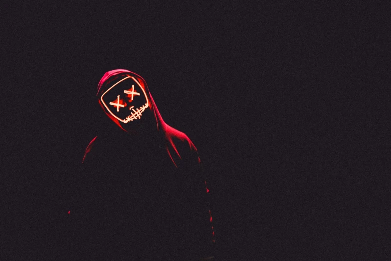 a person wearing a mask in the dark, an album cover, pexels contest winner, minimalism, red hoods, black neon lights, halloween, cross-eyed