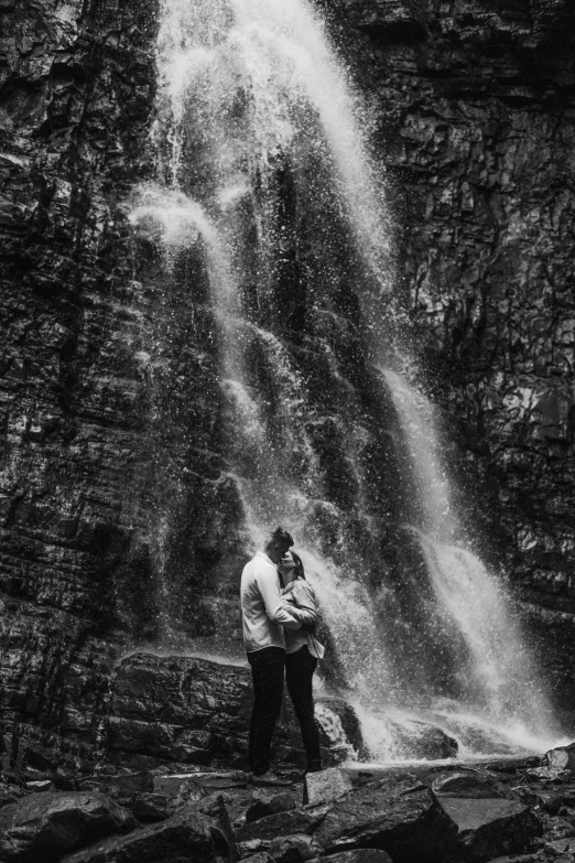 a couple standing in front of a waterfall, a black and white photo, february), - n 9, lovely couple, # film