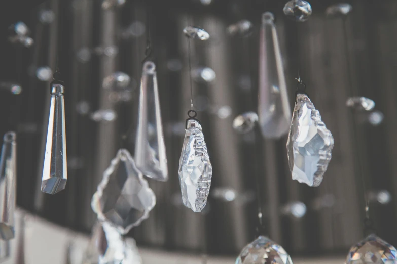 a bunch of crystal hanging from a ceiling, trending on pexels, bokeh chrome accents, an ethereal, diamonds, a crystal palace