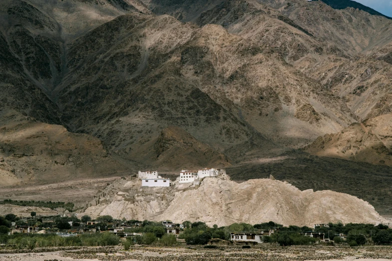 a large white building sitting on top of a mountain, by Tobias Stimmer, indian temple, shot on hasselblad, villages, brown
