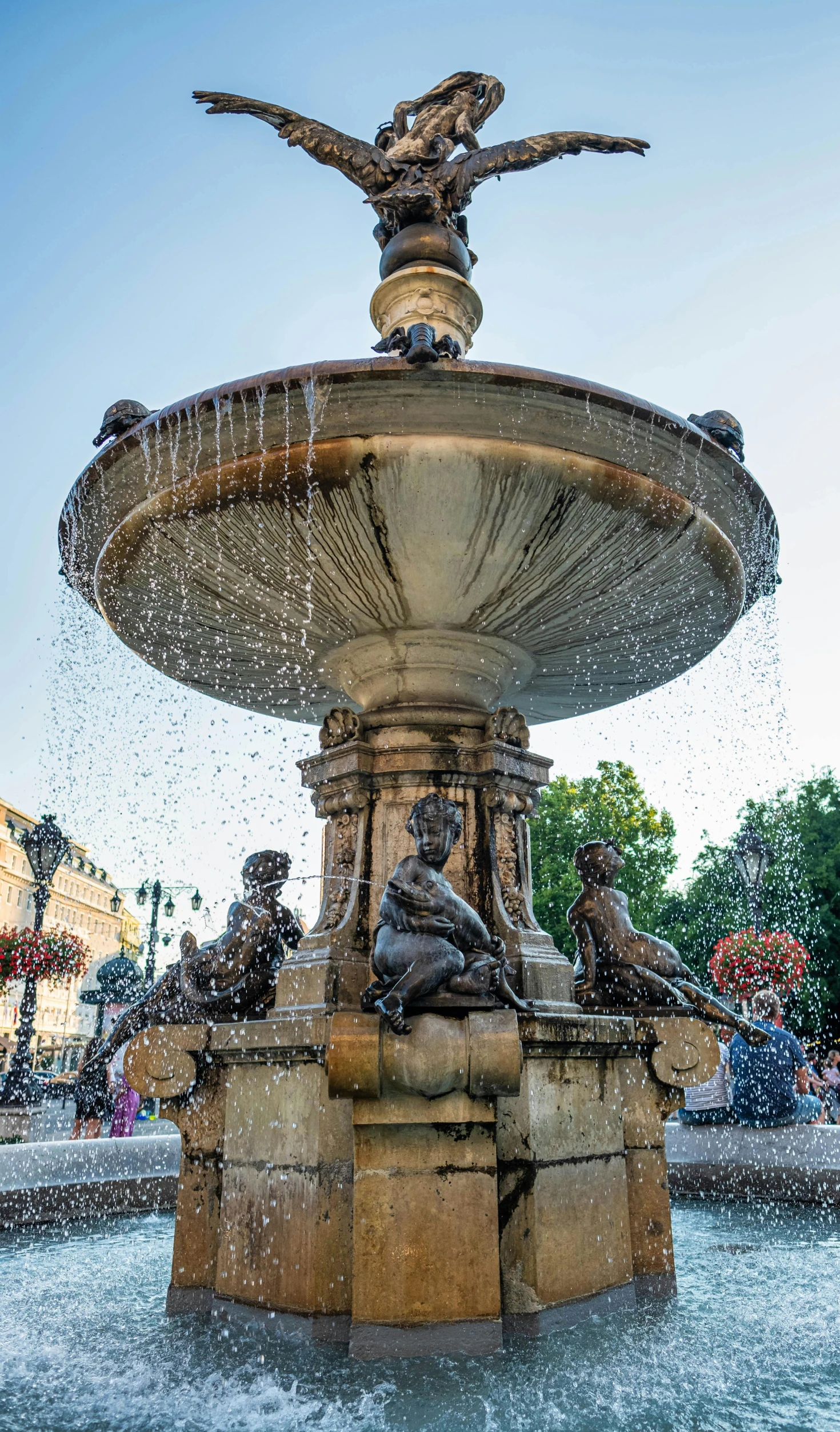 a fountain with a statue on top of it, crowded square, taken with sony a7r camera, children's, square