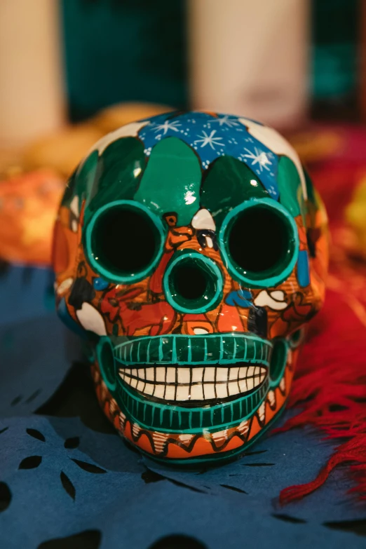 a colorful skull sitting on top of a table, festive, slide show, up close, ceramics