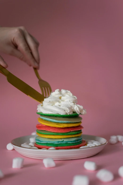 a stack of pancakes sitting on top of a white plate, a colorized photo, by Julia Pishtar, color field, rainbow sheep like cotton candy, whipped cream on top, cake in hand, full product shot