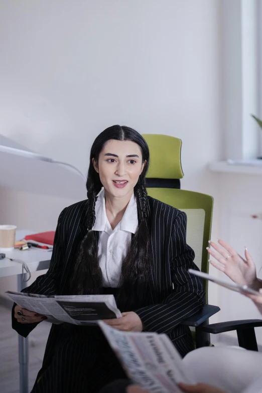 a group of people sitting around a table talking, a colorized photo, inspired by Marina Abramović, girl in a suit, sat in an office, official documentation, professional render