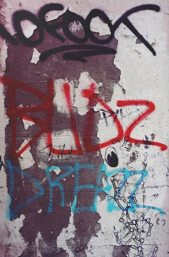 a red fire hydrant sitting next to a wall covered in graffiti, an album cover, by Menez, reddit, grainy damaged photo, oozing bile ), riot, brown red blue