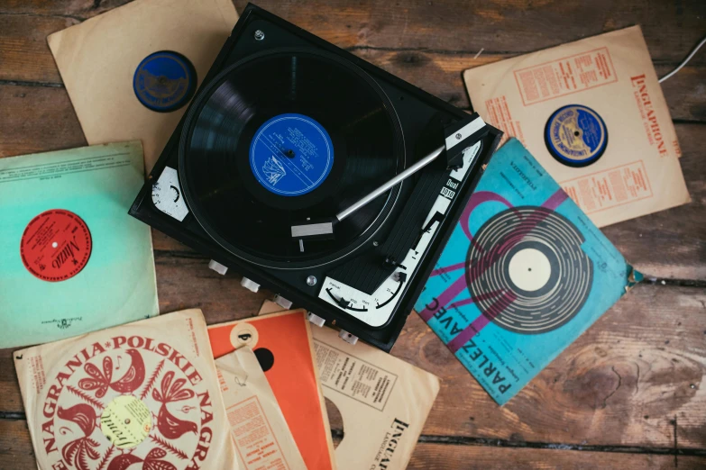 a record player sitting on top of a wooden table, an album cover, pexels contest winner, private press, various styles, old scientific documents, having a good time, as well as scratches