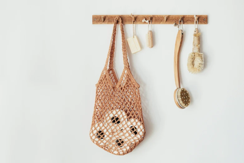 a close up of a bag hanging on a wall, trending on pexels, natural materials, washy brush, shopping groceries, crochet skin