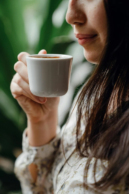 a close up of a person holding a cup of coffee, jen atkin, thoughtful, long coffee brown hair, full product shot