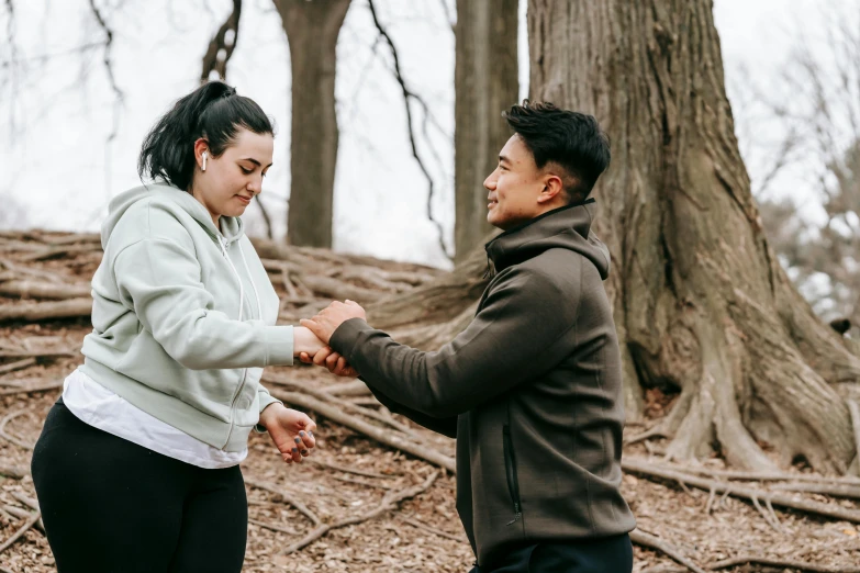 a man and woman holding hands in the woods, pexels contest winner, hurufiyya, working out in the field, jordan grimmer and natasha tan, sydney park, darren quach