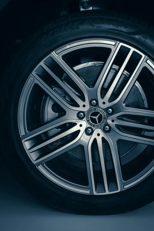 a close up of a tire on a car, in gunmetal grey, desaturated blue, mercedez benz, multi-part