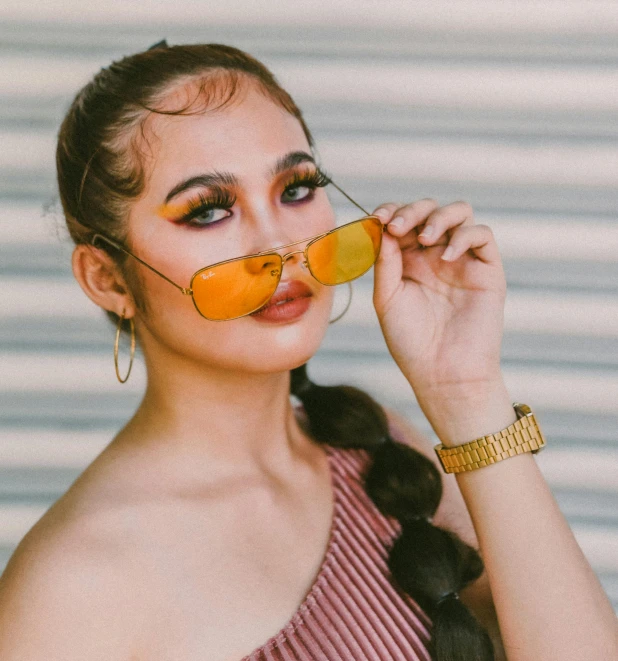 a woman with orange slices in her mouth, an album cover, inspired by Natasha Tan, trending on pexels, realism, gold glasses, lalisa manobal, casual pose, woman in streetwear
