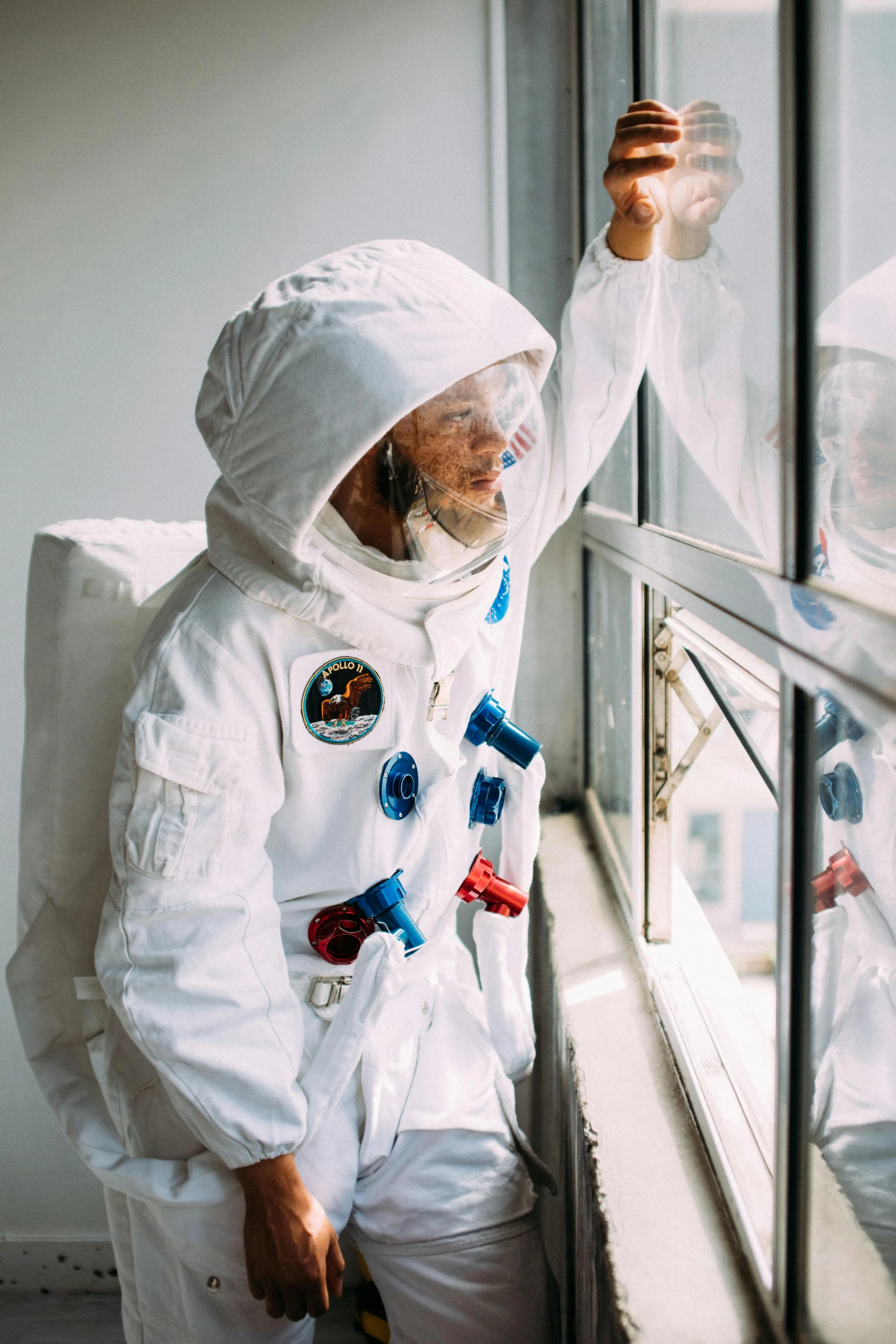 two people in spacesuits looking out a window, profile image, a man wearing a backpack, wearing a white robe, maintenance