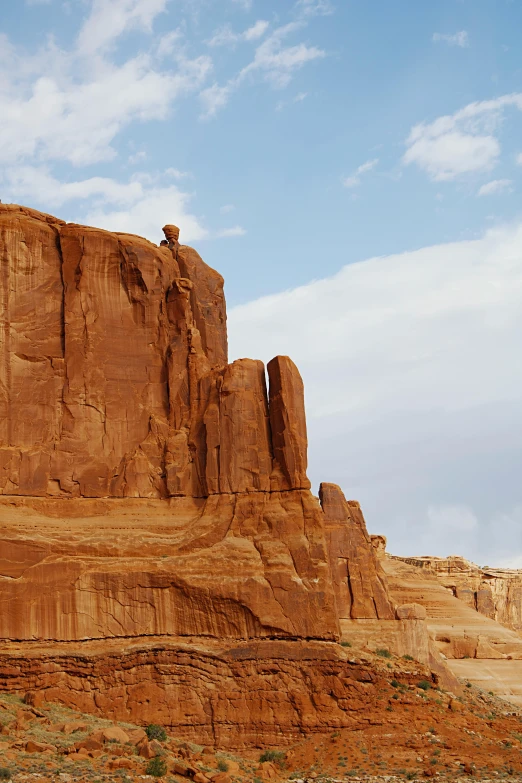 a large rock formation in the middle of a desert, by Linda Sutton, unsplash, tall thin build, an eagle, arches, taken in the late 2010s