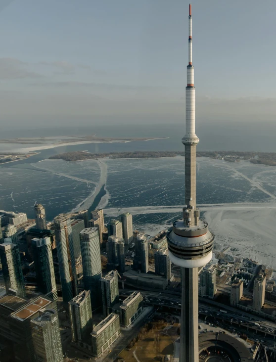 a very tall tower sitting in the middle of a city, by Ryan Pancoast, pexels contest winner, hurufiyya, toronto city, ice city in 2 0 8 0, helicopter footage over city, 2 0 2 2 photo