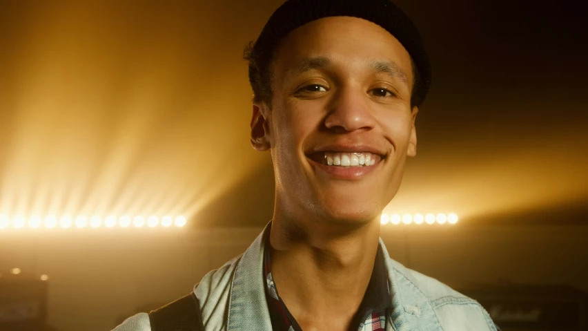 a close up of a person smiling at the camera, by Jacob Toorenvliet, singer in the voice show, light skin, full scene shot, high quality upload