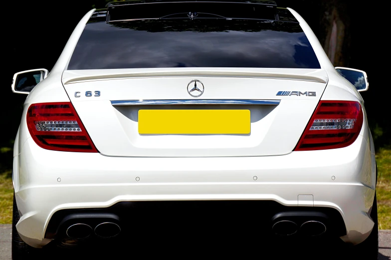 a white car parked on the side of the road, by Keos Masons, rear lighting, mercedes, glossy white metal, full plate