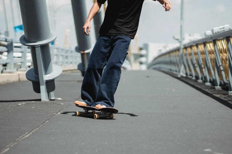 a man riding a skateboard down a sidewalk, a picture, baggy jeans, melbourne, on a wooden desk, 15081959 21121991 01012000 4k