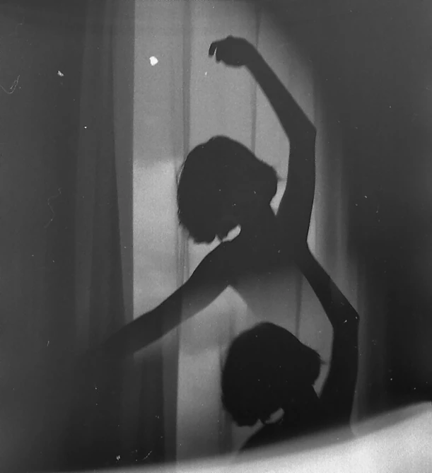 a black and white photo of a person standing in front of a window, inspired by Lillian Bassman, tumblr, dancing with each other, ✨🕌🌙, brittney lee, with a mirror