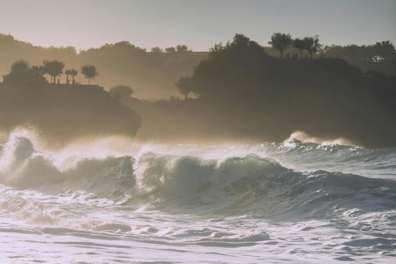 a person riding a surfboard on a wave in the ocean, pexels contest winner, romanticism, morning haze, coastal cliffs, bali, cyprus