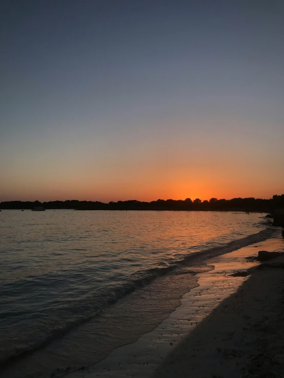 the sun is setting over a body of water, a picture, by Robbie Trevino, beautiful italian beach scene, uncropped, long view, uploaded