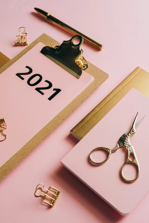 a notepad sitting on top of a clipboard next to a pair of scissors, by Julia Pishtar, happening, new years eve, thumbnail, pink, 2021