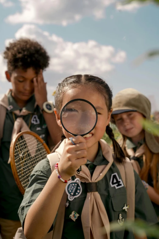 a girl scout looking through a magnifying glass, a picture, trending on pexels, renaissance, film still promotional image, group photo, tan, kids