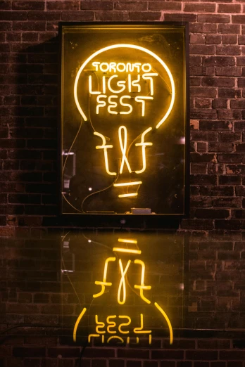 a neon sign in front of a brick wall, by Matt Cavotta, unsplash contest winner, toronto, summer festival night, an upright lightbulb, reflected light