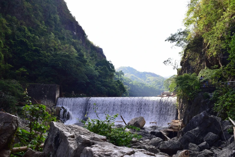 a waterfall in the middle of a lush green forest, pexels contest winner, hurufiyya, paddy fields and river flowing, 2 5 6 x 2 5 6 pixels, a lake between mountains, wall of water either side