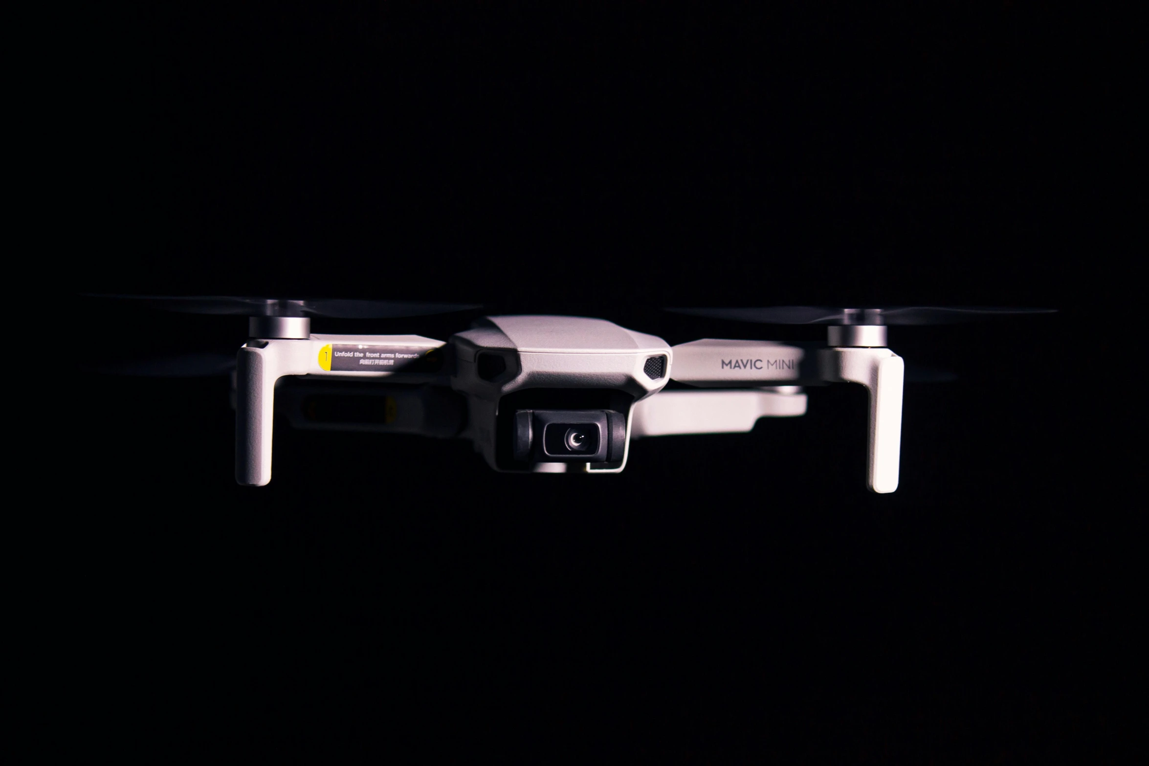 a small white drone flying in the dark, unsplash, bauhaus, silver and yellow color scheme, 🕹️ 😎 🔫 🤖 🚬, micro detailed, high fov