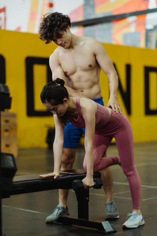 a man and a woman doing push ups on a bench, by Jang Seung-eop, wearing yellow croptop, adam ondra, standing posture, ad image