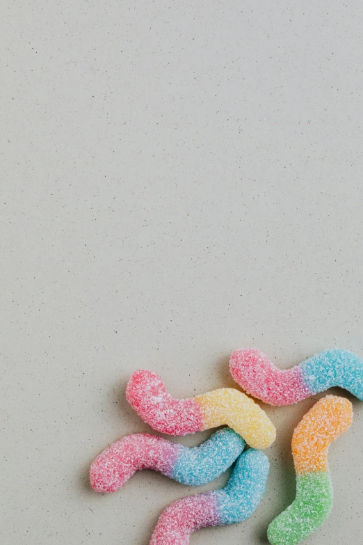 a pile of gummy worms sitting on top of a table, unsplash, 2 5 6 x 2 5 6 pixels, candy pastel, gumdrop bunnies, background image