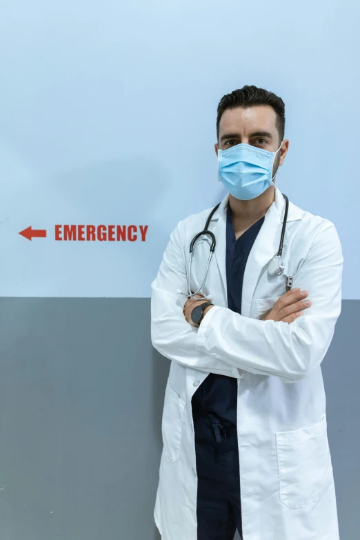 a man in a lab coat wearing a face mask, a stock photo, shutterstock, emergency room, backdrop, dan eder, quackery