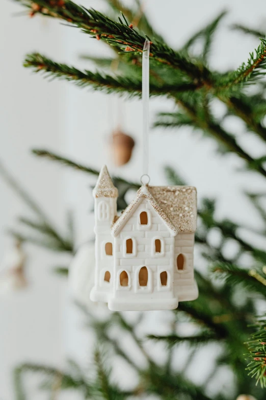 a white house ornament hanging from a christmas tree, unsplash, folk art, alabaster gothic cathedral, beautifully soft lit, detailed product image, zoomed in