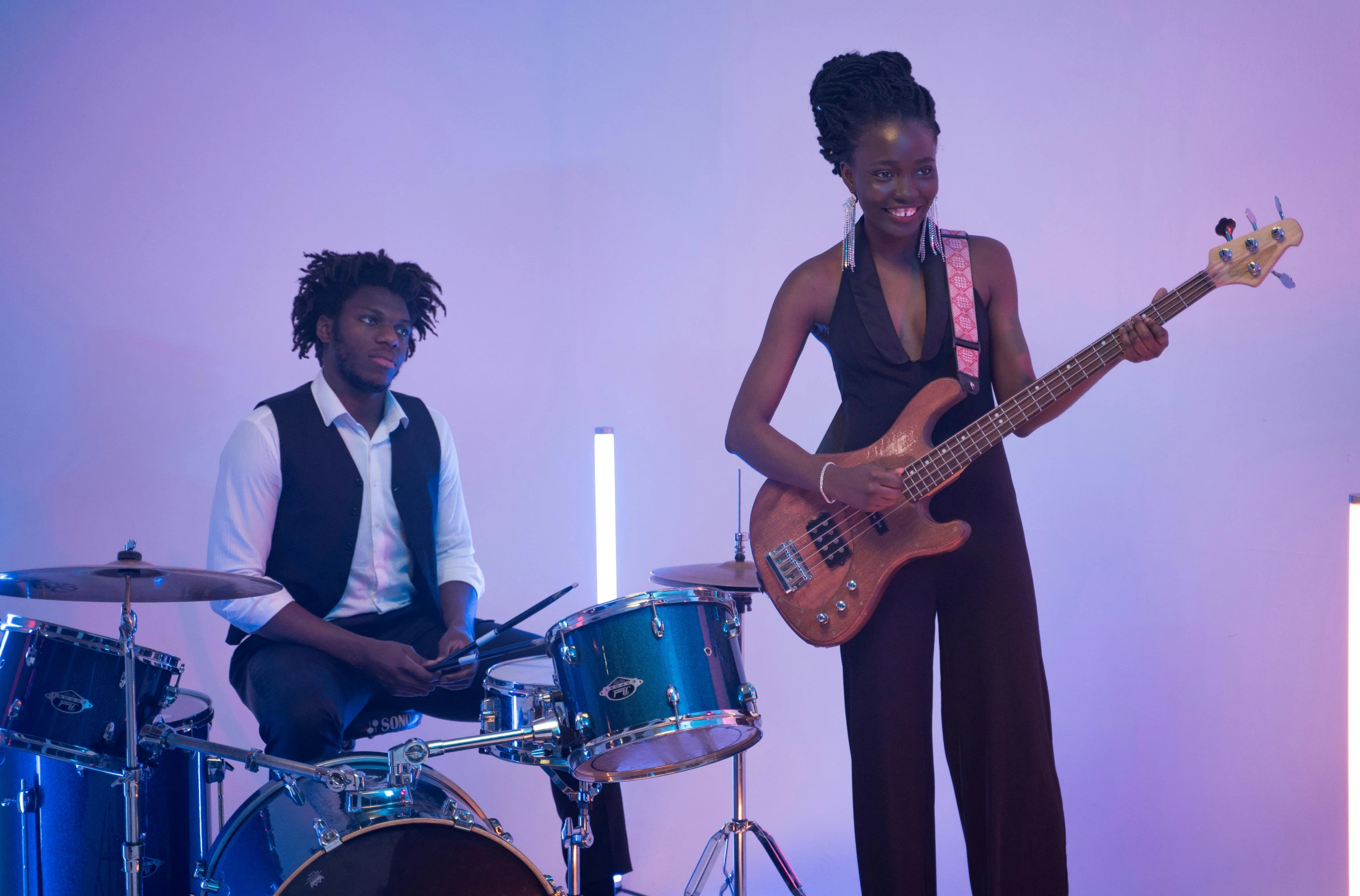 a woman standing next to a man holding a guitar, pexels, funk art, playing drums, lupita nyong'o, bass drum, 15081959 21121991 01012000 4k