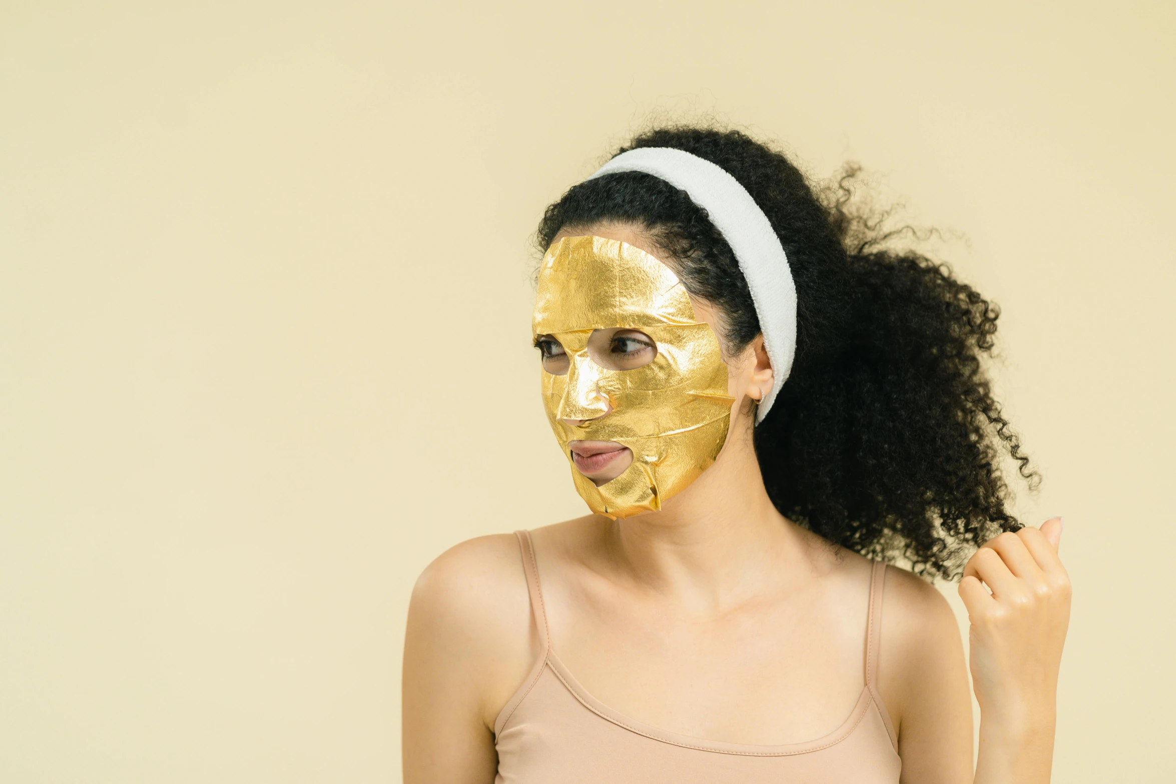 a woman with a gold mask on her face, trending on pexels, clear [bronze] face, manuka, full body image, brunette
