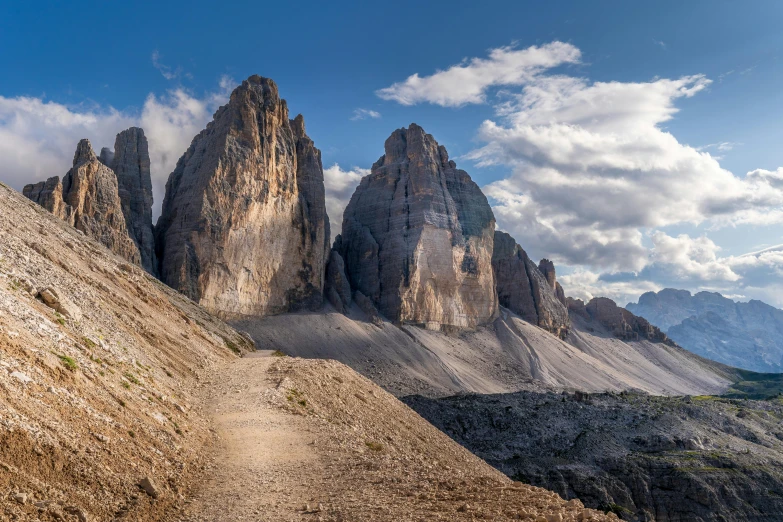 a trail going up the side of a mountain, by Carlo Martini, pexels contest winner, tall stone spires, panorama, thumbnail, afternoon