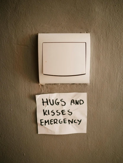 a sign on a wall that says hugs and kisses emergency, by Elsa Bleda, trending on pexels, fridge, queer, switches, 1990's
