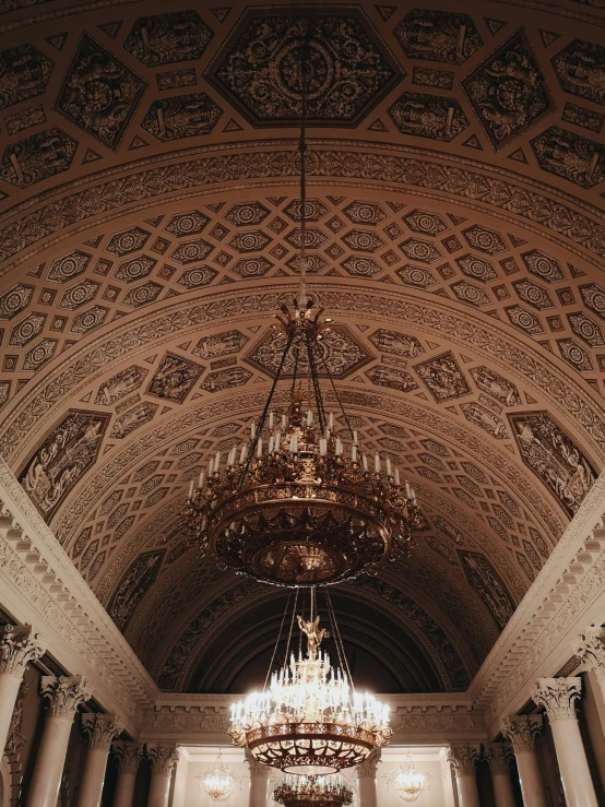 a chandelier hanging from the ceiling of a building, a photo, by Anna Haifisch, unsplash contest winner, neoclassicism, big arches in the back, 2 5 6 x 2 5 6 pixels, concert photo, ornate with gold trimmings