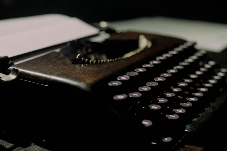 an old typewriter sitting on top of a table, by Carey Morris, pexels contest winner, private press, background image, dark. no text, psion, brown