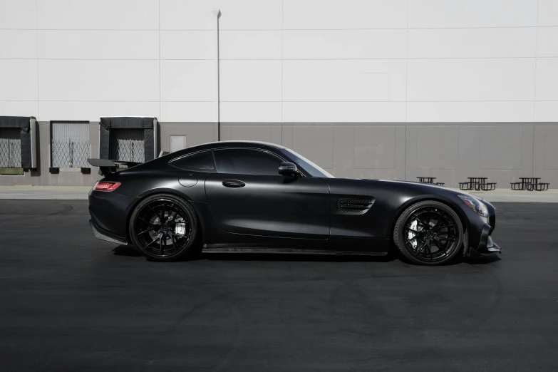 a black sports car parked in a parking lot, a portrait, unsplash, ( side ) profile, full body full height, venom, stacked