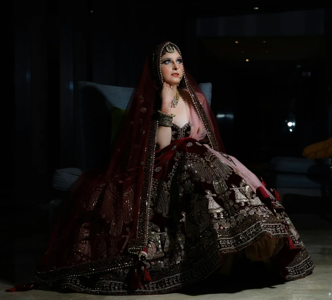 a woman in a bridal dress sitting on the floor, inspired by Saurabh Jethani, pexels, baroque, maroon, with a black background, instagram photo, rectangle