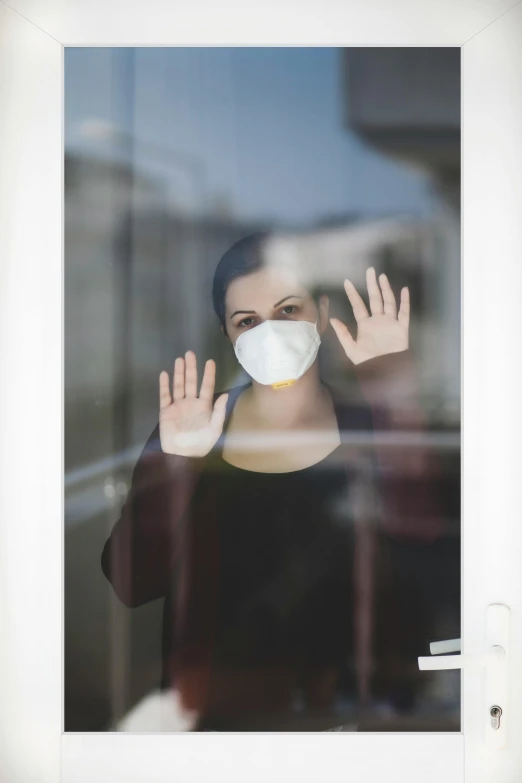 a woman wearing a face mask behind a window, happening, hands shielding face, leaving a room, monika