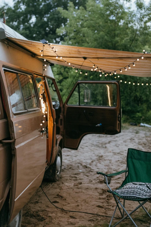 a camper van parked on the side of a dirt road, unsplash contest winner, renaissance, string lights, decorations, awnings, retro stylised