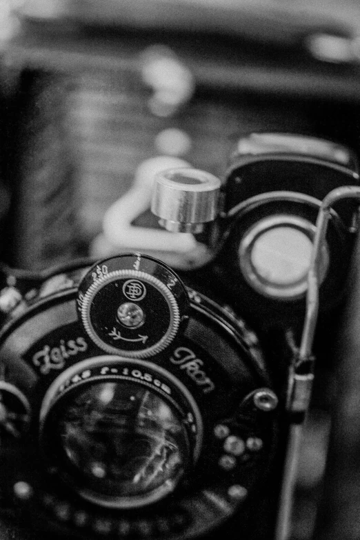 a black and white photo of an old camera, inspired by Germaine Krull, unsplash, medium format, low detail, looking happy, black & white photo