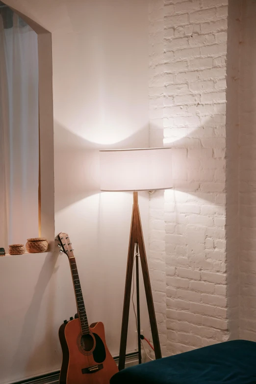 a bed room with a bed a guitar and a window, inspired by Isamu Noguchi, unsplash, light and space, soft butterfly lighting, curved. studio lighting, floor lamps, light cone